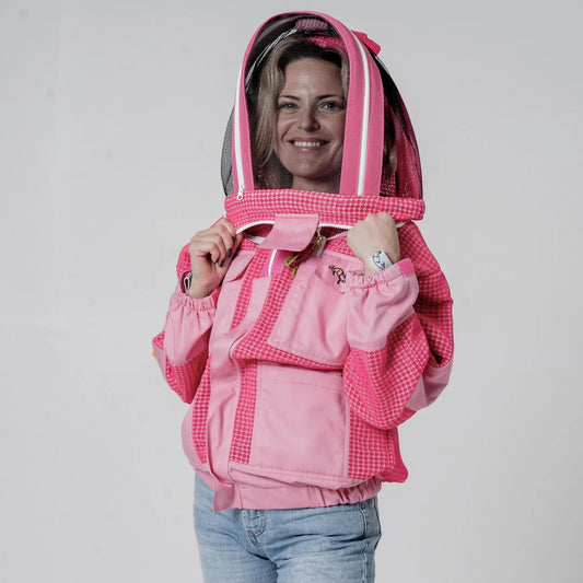 Woman wearing OZ Armour pink 3 layer mesh beekeeping jacket with fencing veil hood up, front view