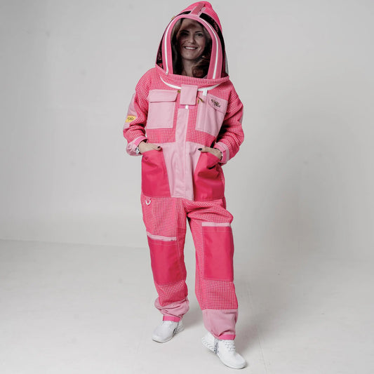 Woman wearing OZ Armour pink 3 layer mesh beekeeping suit with fencing veil hood up, front view
