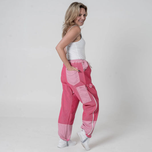 Woman wearing OZ Armour pink 3 layer mesh beekeeping trousers, three quarter back view with hands in pockets