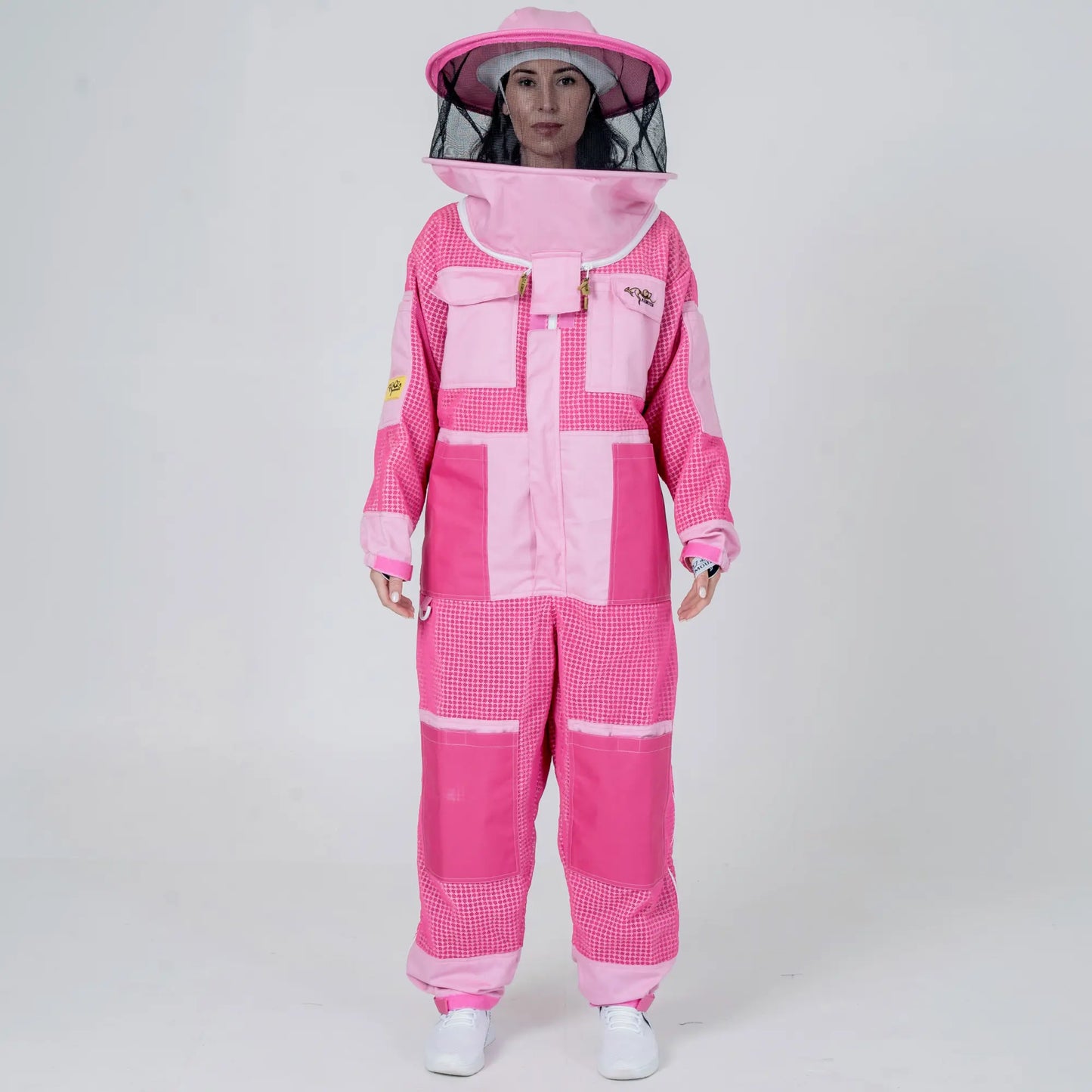 Woman wearing 3 layer mesh pink beekeeping suit with round veil hat, front view