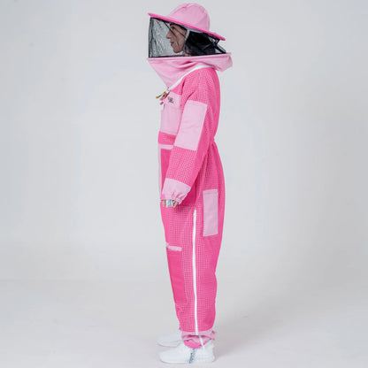 Side view of woman wearing 3 layer mesh pink beekeeping suit with round veil hat
