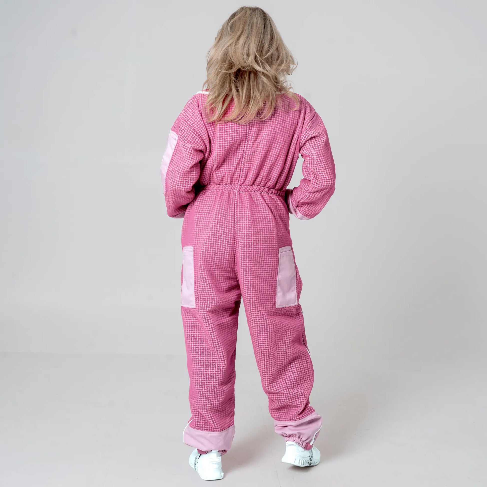 Back view of woman wearing 3 layer mesh pink beekeeping suit