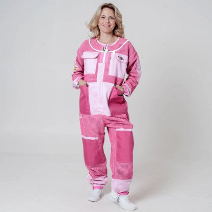 Woman wearing 3 layer mesh pink beekeeping suit without veil, front view with hands in pockets