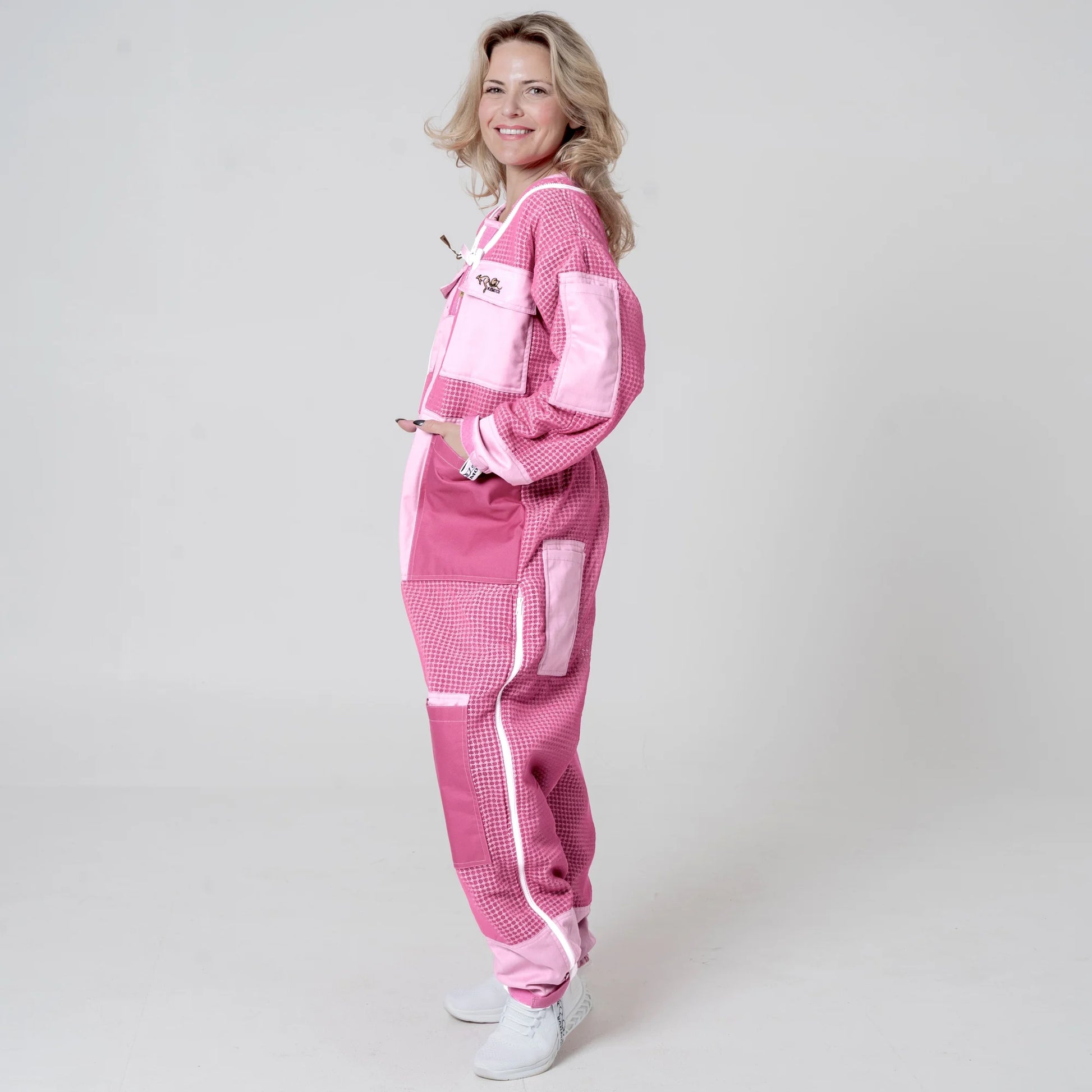 Side view of woman wearing 3 layer mesh pink beekeeping suit