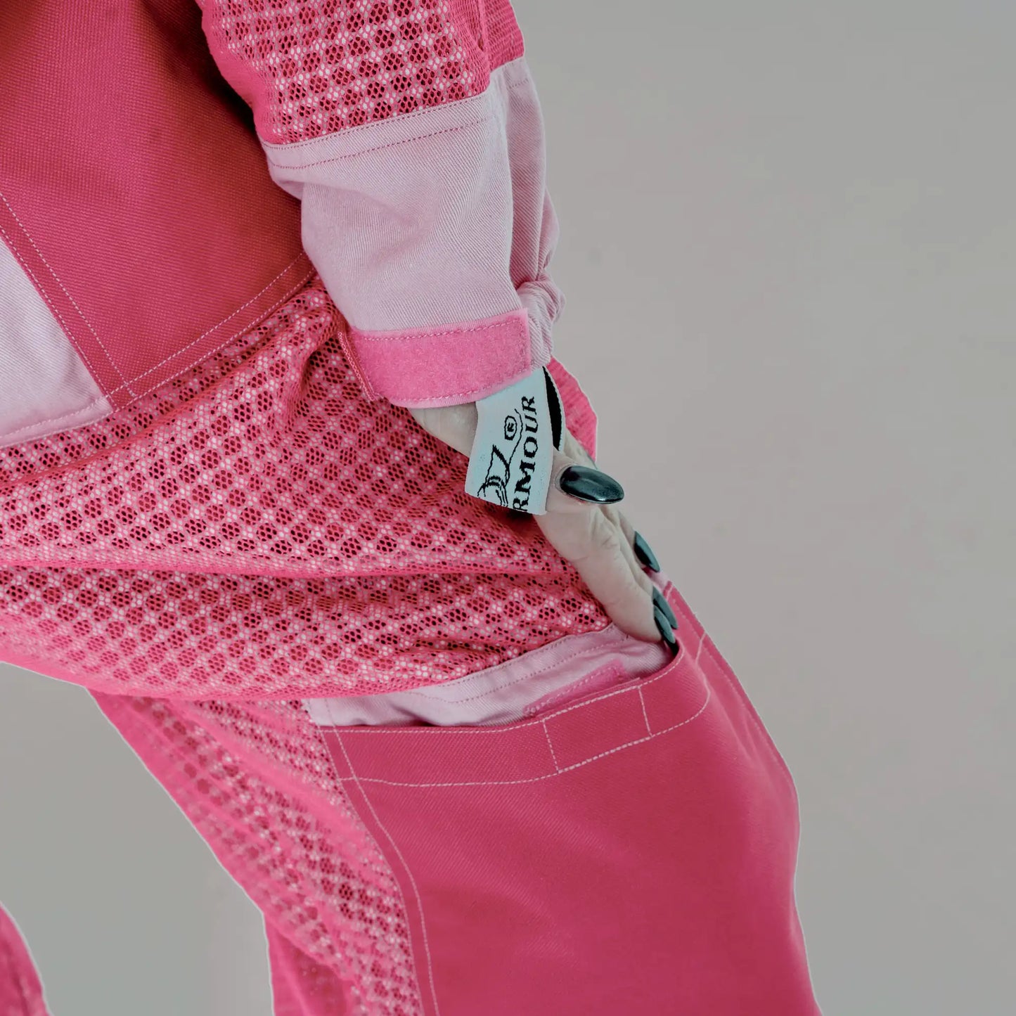 Close up of sleeve cuff with OZ Armour logo patch on the 3 layer mesh pink beekeeping suit