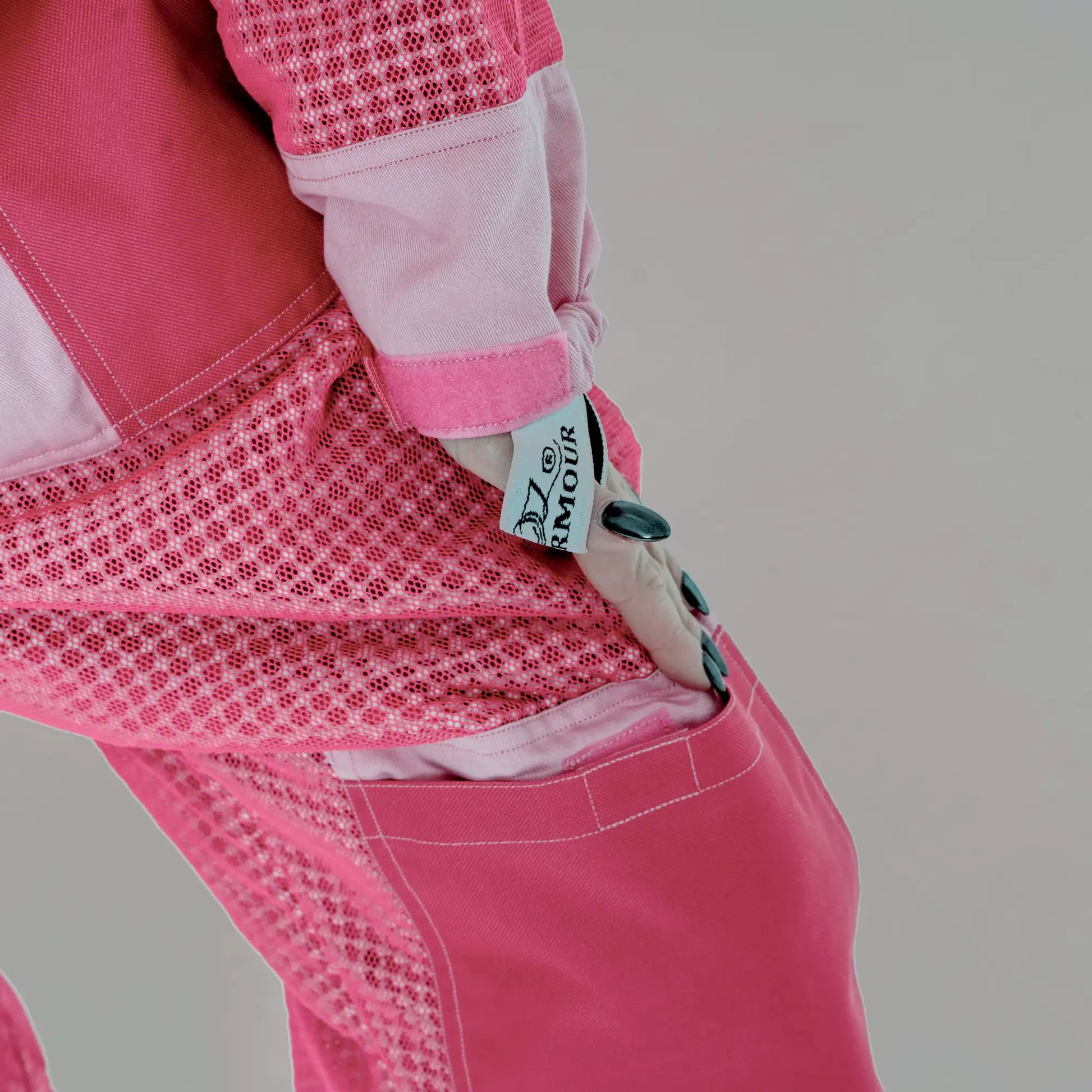 Close up of sleeve cuff with OZ Armour logo patch on the 3 layer mesh pink beekeeping suit