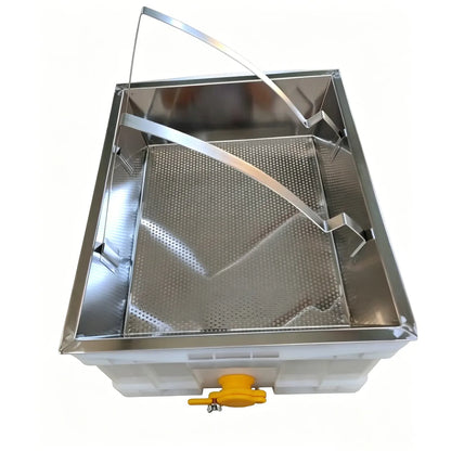 Perforated stainless steel grate draining honey from wax cappings into tub below