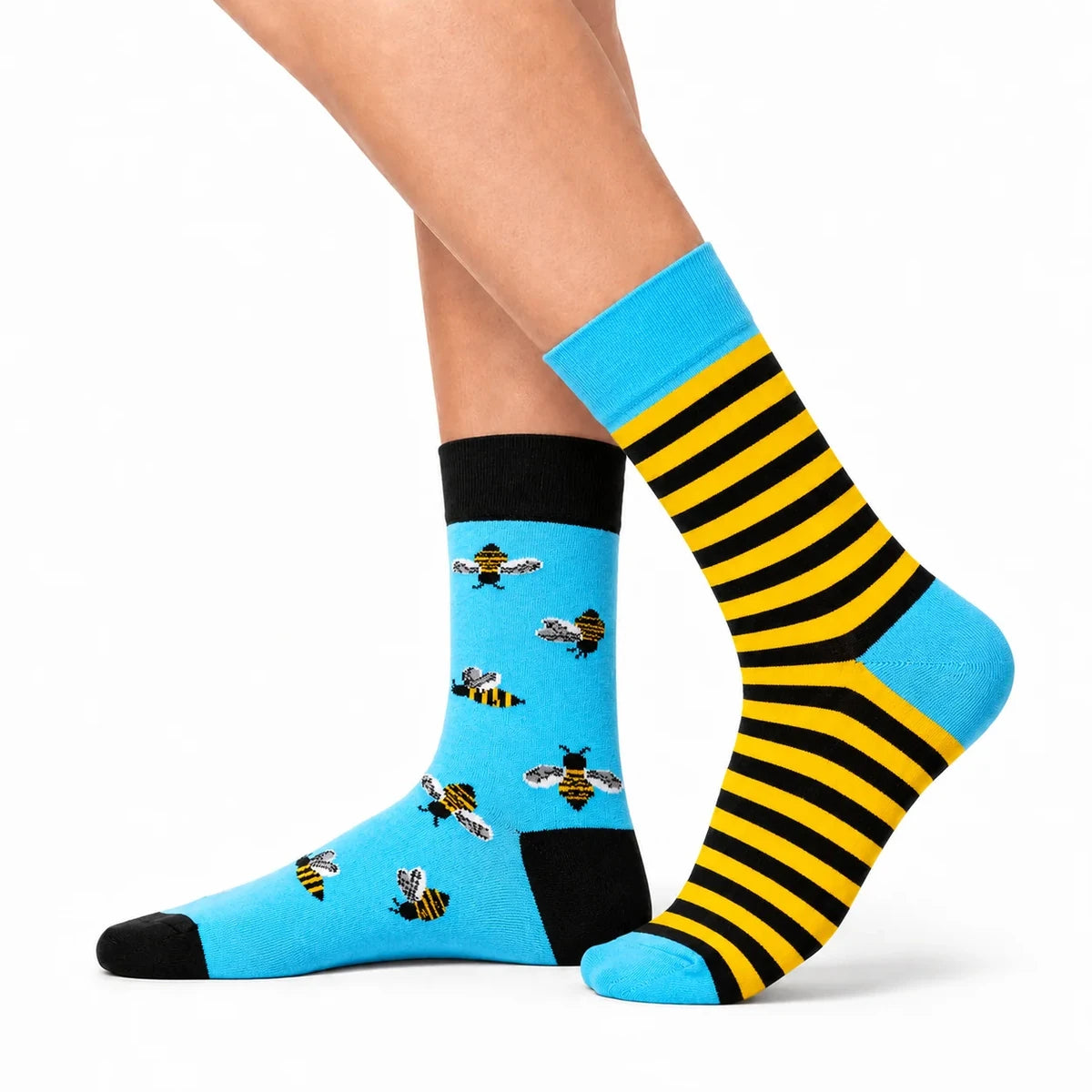 Side view of bee socks being worn, showing crew length on the calf
