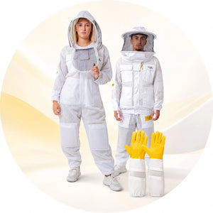 Man and woman wearing white ventilated beekeeping suits with veils, beside yellow leather beekeeping gloves