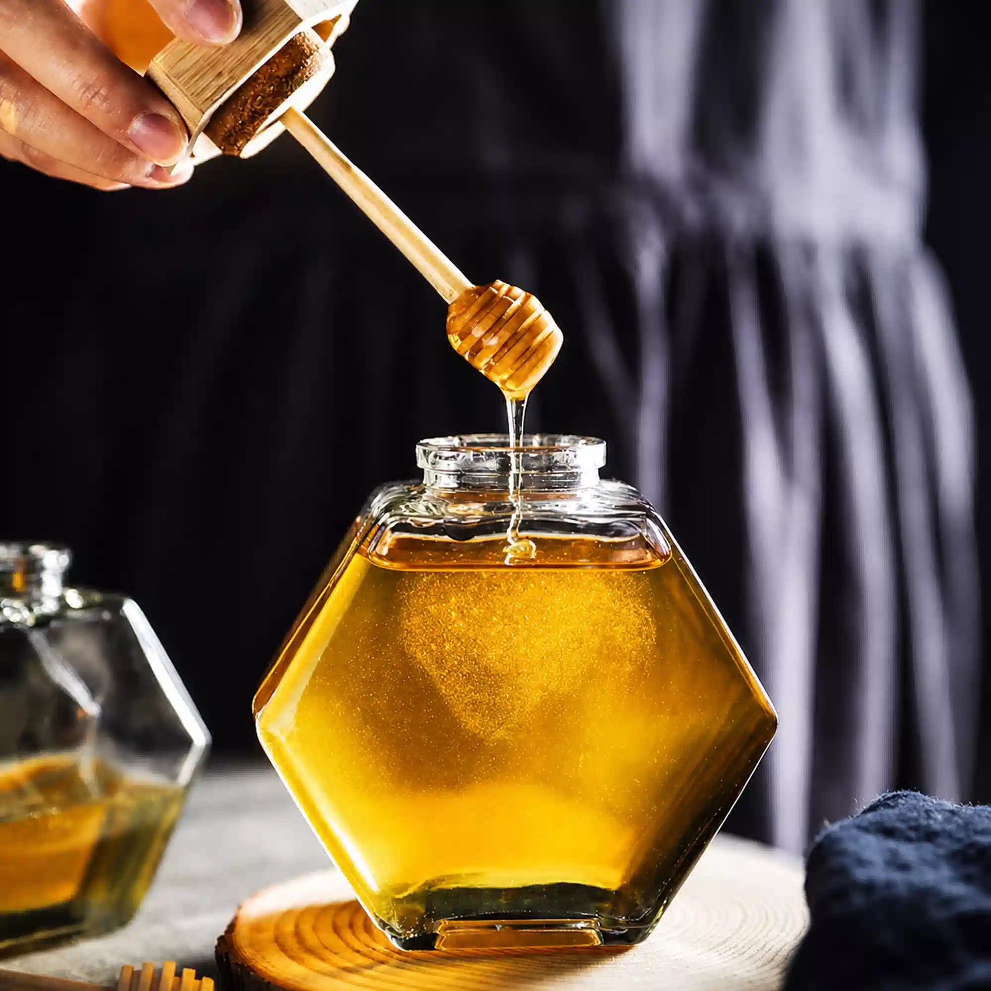 Hexagon glass honey jar with wooden lid and honey dipper
