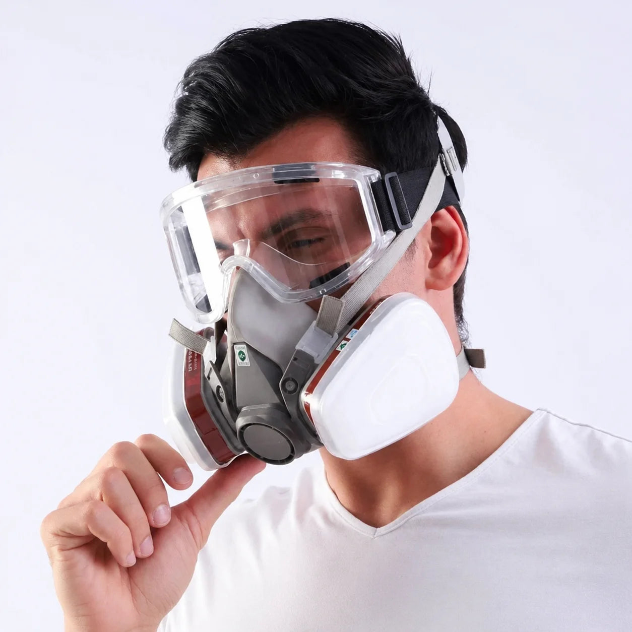 Man wearing half face respirator with safety goggles for oxalic acid vaporization beekeeping