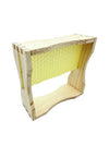 Honeycomb wooden frame with honey dripping.