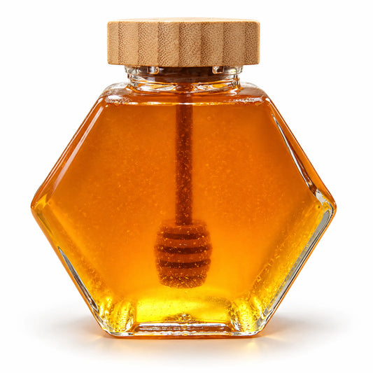 Hexagon glass jar of 300g raw organic Bloodwood honey with a bamboo lid and wooden honey dipper on a white background