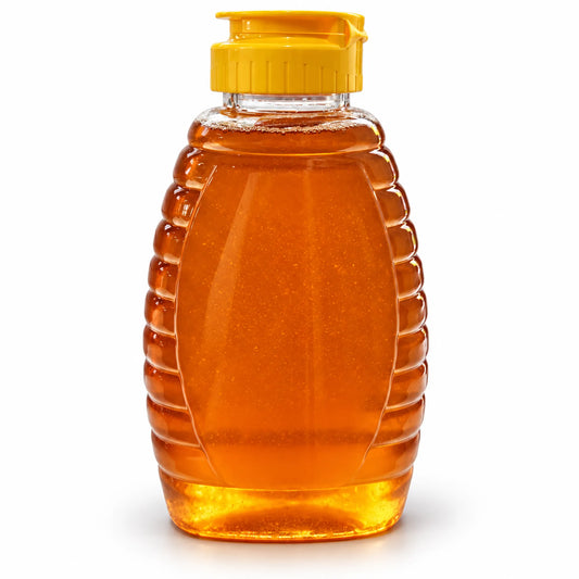 500g squeeze jar of raw organic Bloodwood honey with ribbed sides and a yellow flip-top cap on a white background