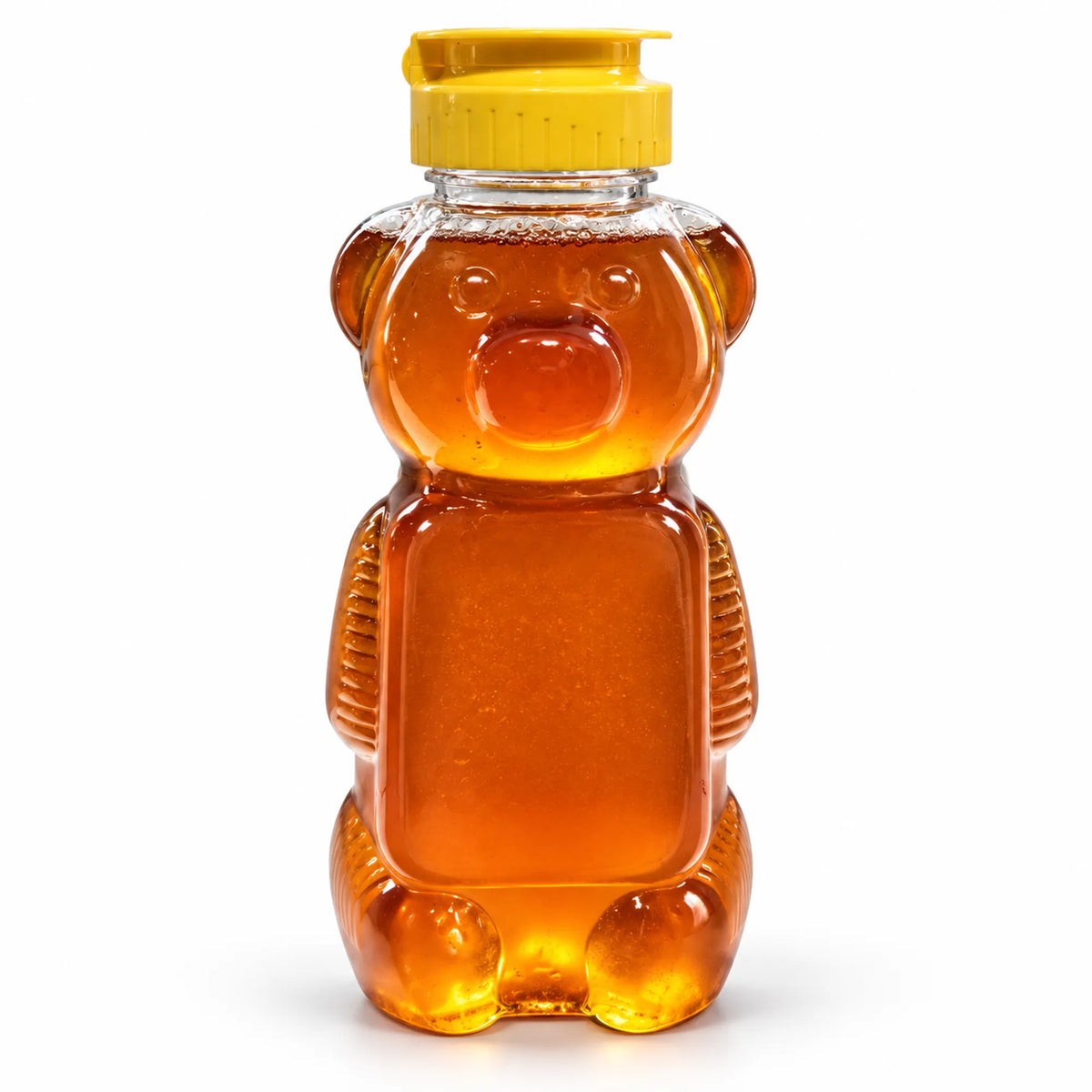 Honey bear squeeze jar filled with 700g of raw organic Bloodwood honey with a yellow flip-top cap on a white background

