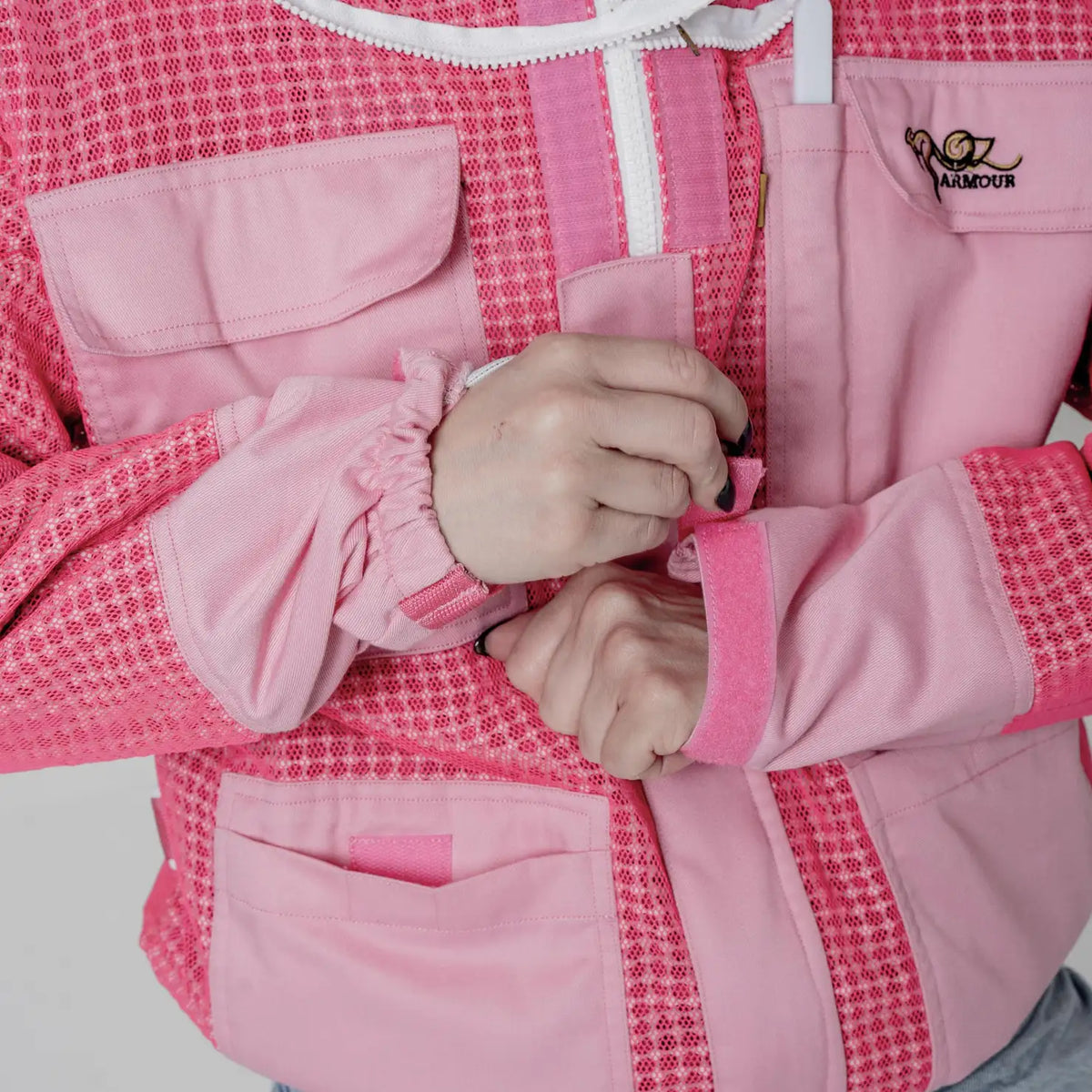 Close up of the elastic wrist cuff with adjustable velcro strap on the OZ Armour pink 3 layer beekeeping jacket