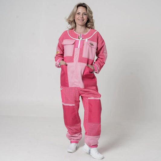 Woman wearing OZ Armour pink 3 layer mesh beekeeping suit with hood removed, front view with hands in pockets