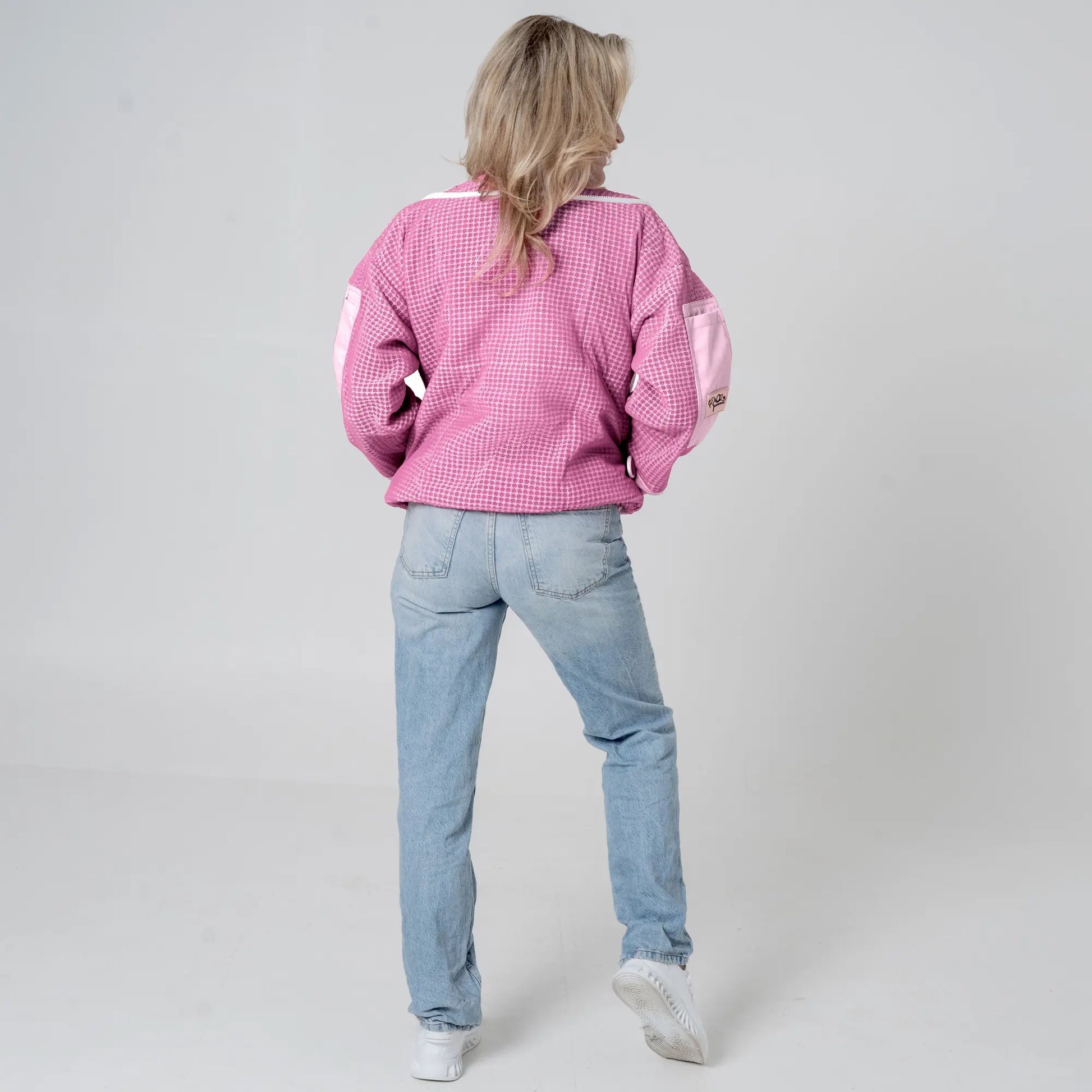 Woman wearing OZ ARMOUR pink beekeeping jacket over jeans, back view full body