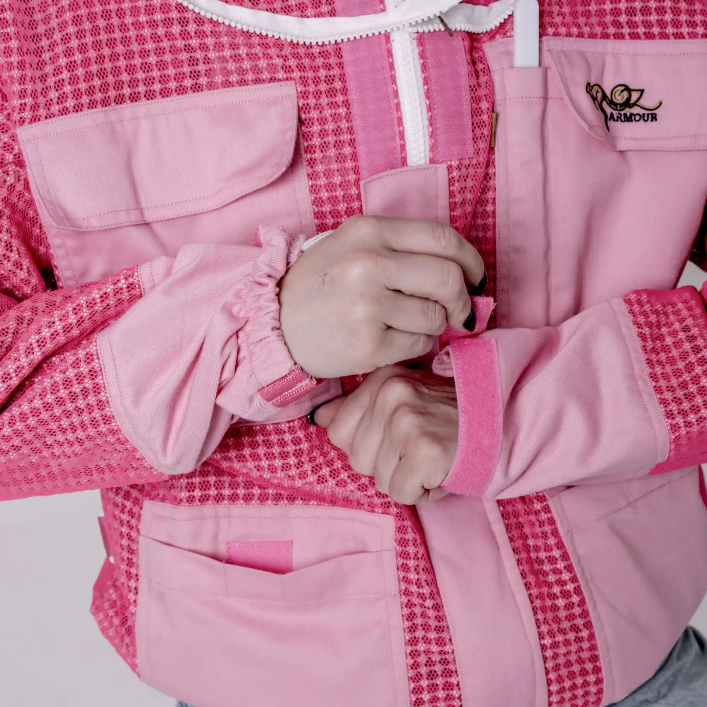 lose up of collar and front zip pull on the OZ ARMOUR pink beekeeping jacket