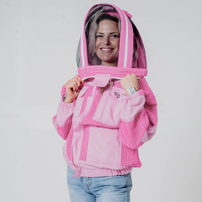 Woman wearing OZ ARMOUR pink beekeeping jacket with fencing veil hood up, front view
