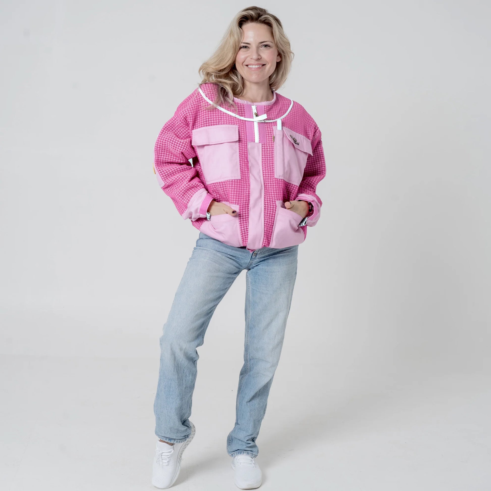 Woman wearing OZ ARMOUR pink beekeeping jacket over jeans, front view full body