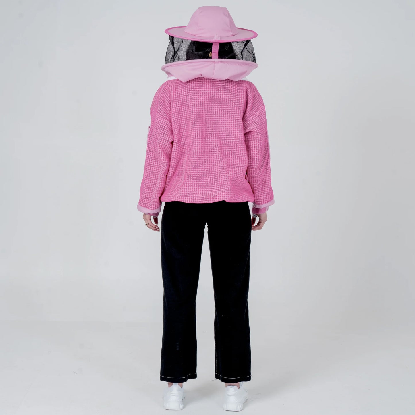 Woman wearing OZ ARMOUR pink beekeeping jacket with round veil hat, back view full body