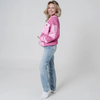 oman wearing OZ ARMOUR pink beekeeping jacket over jeans, side view full body
