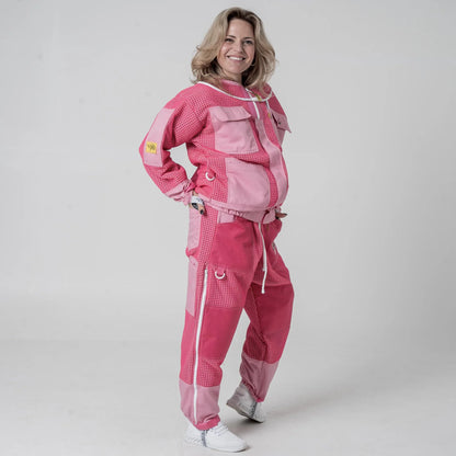 Woman wearing OZ Armour pink beekeeping jacket and trouser set, front pose with hand on hip
