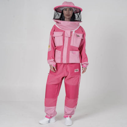 Woman wearing OZ Armour pink beekeeping jacket and trouser set with round hat veil hood up, front view
