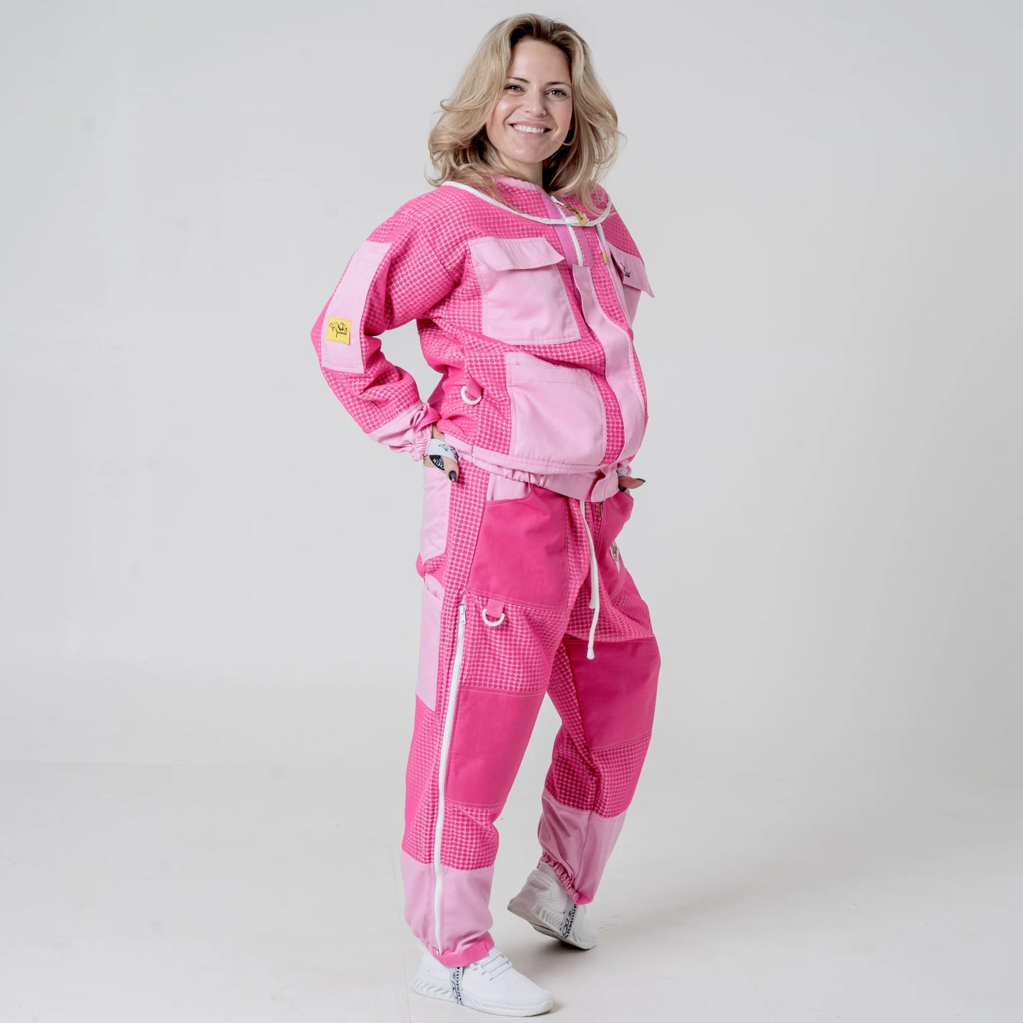Woman wearing OZ ARMOUR pink beekeeping jacket and trousers set