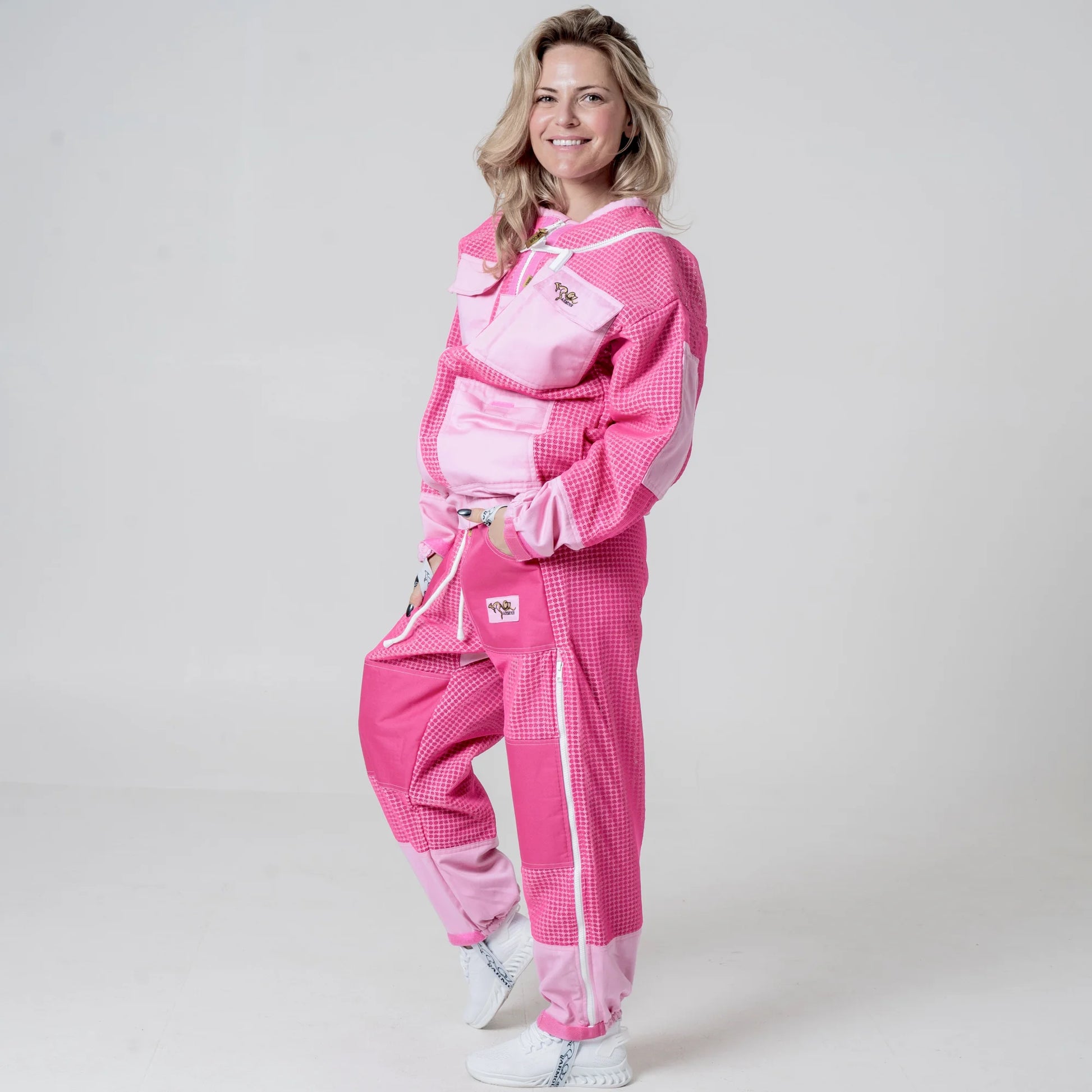 Woman wearing OZ ARMOUR pink beekeeping jacket and trousers set side view
