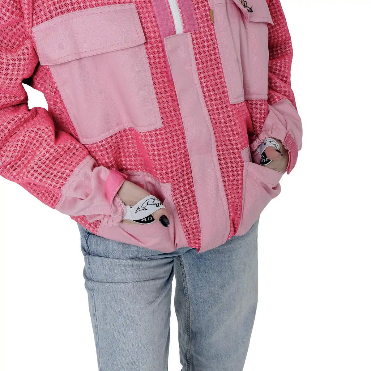 Close up of front pockets with hands inside on the OZ ARMOUR pink beekeeping jacket