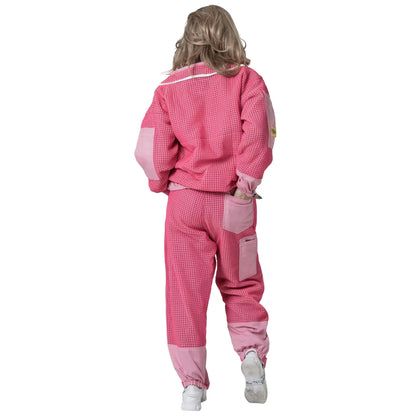 Woman walking in the OZ ARMOUR pink jacket and trousers set, back view