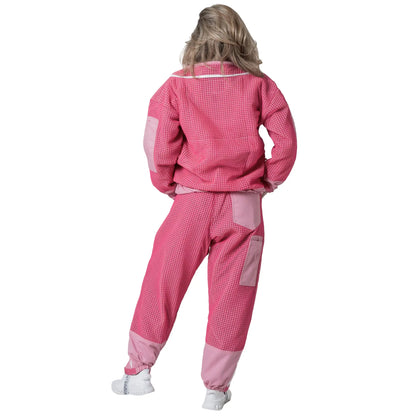 Woman wearing OZ ARMOUR pink jacket and trousers set with hood down, back view