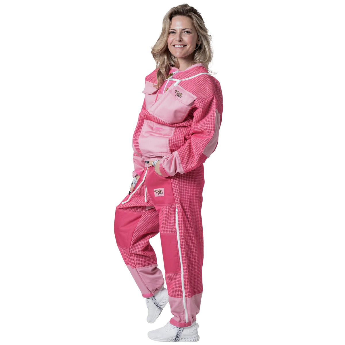 Woman wearing OZ ARMOUR pink jacket and trousers set with fencing veil hood down, front view