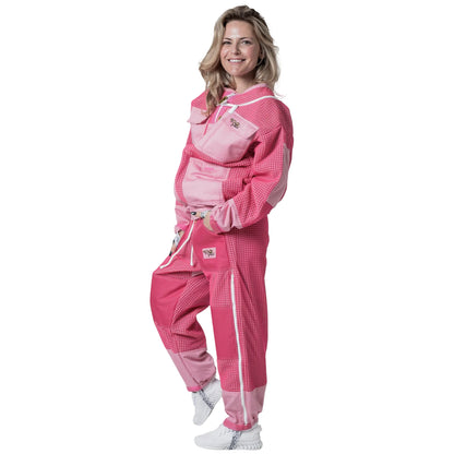 Woman wearing OZ ARMOUR pink jacket and trousers set with fencing veil hood down, front view