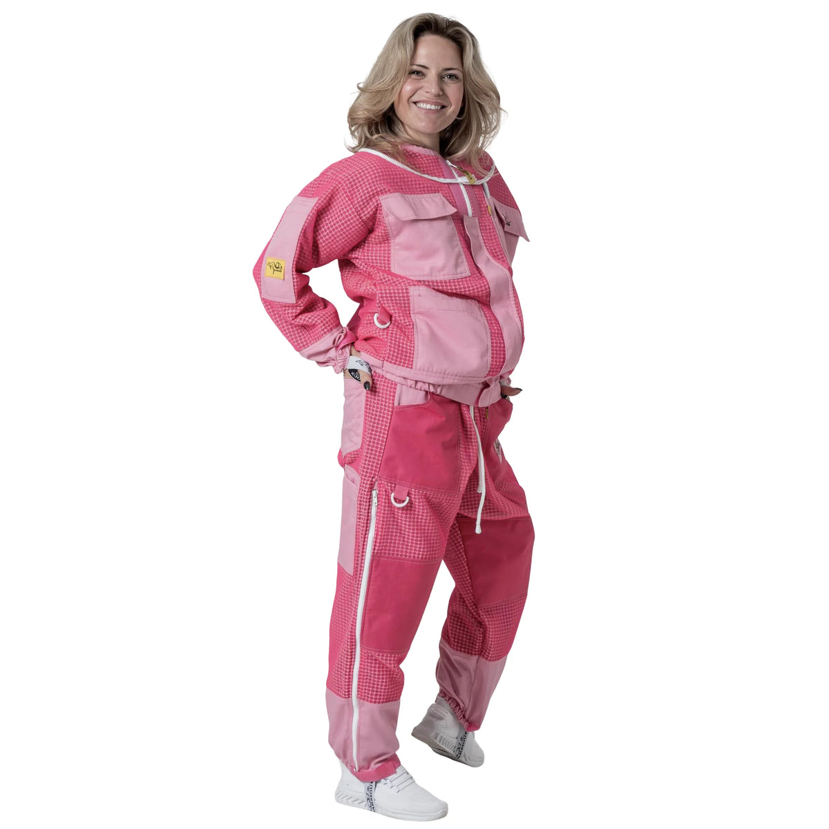 Woman wearing OZ ARMOUR pink jacket and trousers set with hood down, side view