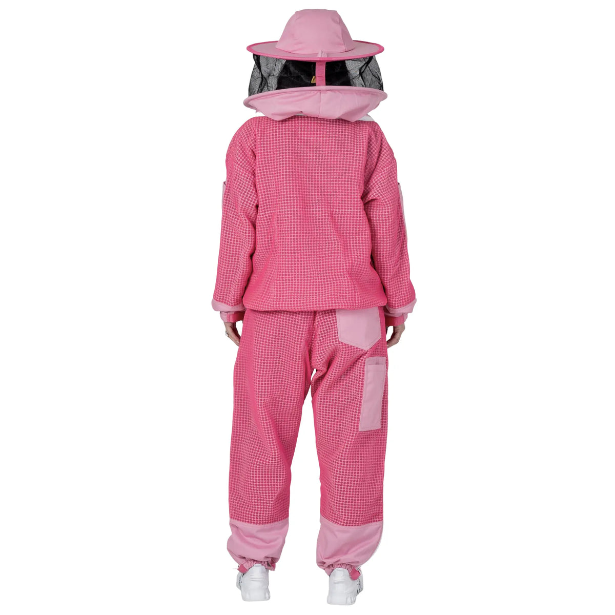 Woman wearing OZ ARMOUR pink jacket and trousers set with round hat veil, back view