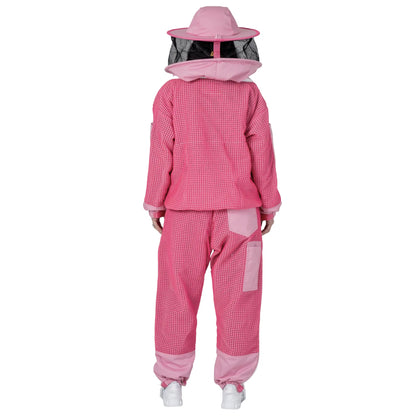 Woman wearing OZ ARMOUR pink jacket and trousers set with round hat veil, back view