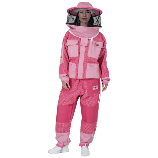 Woman wearing OZ ARMOUR pink jacket and trousers set with round hat veil, front view