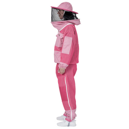 Woman wearing OZ ARMOUR pink jacket and trousers set with round hat veil, side view