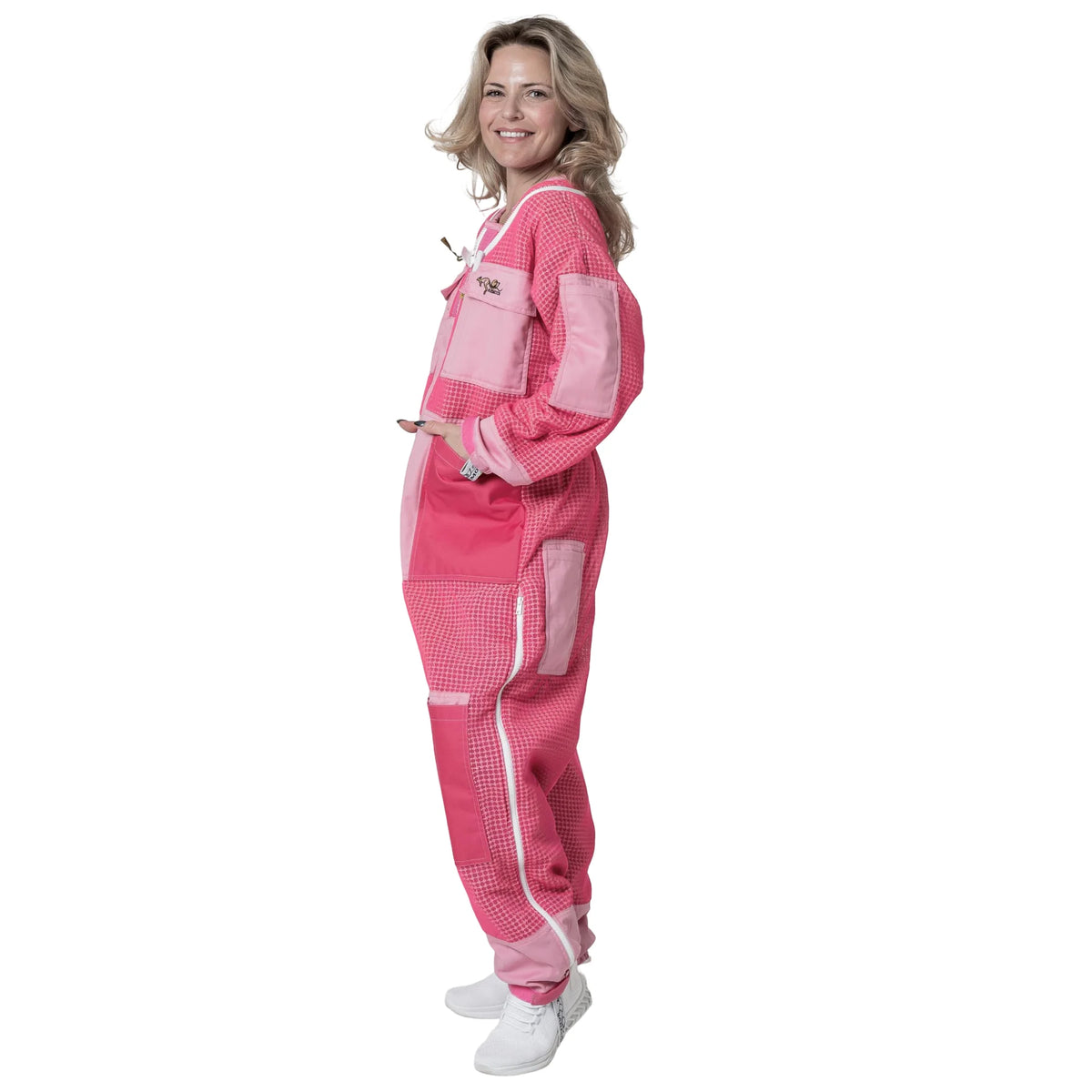 Woman wearing 3 Layer OZ Armour pink suit with hood down, side view