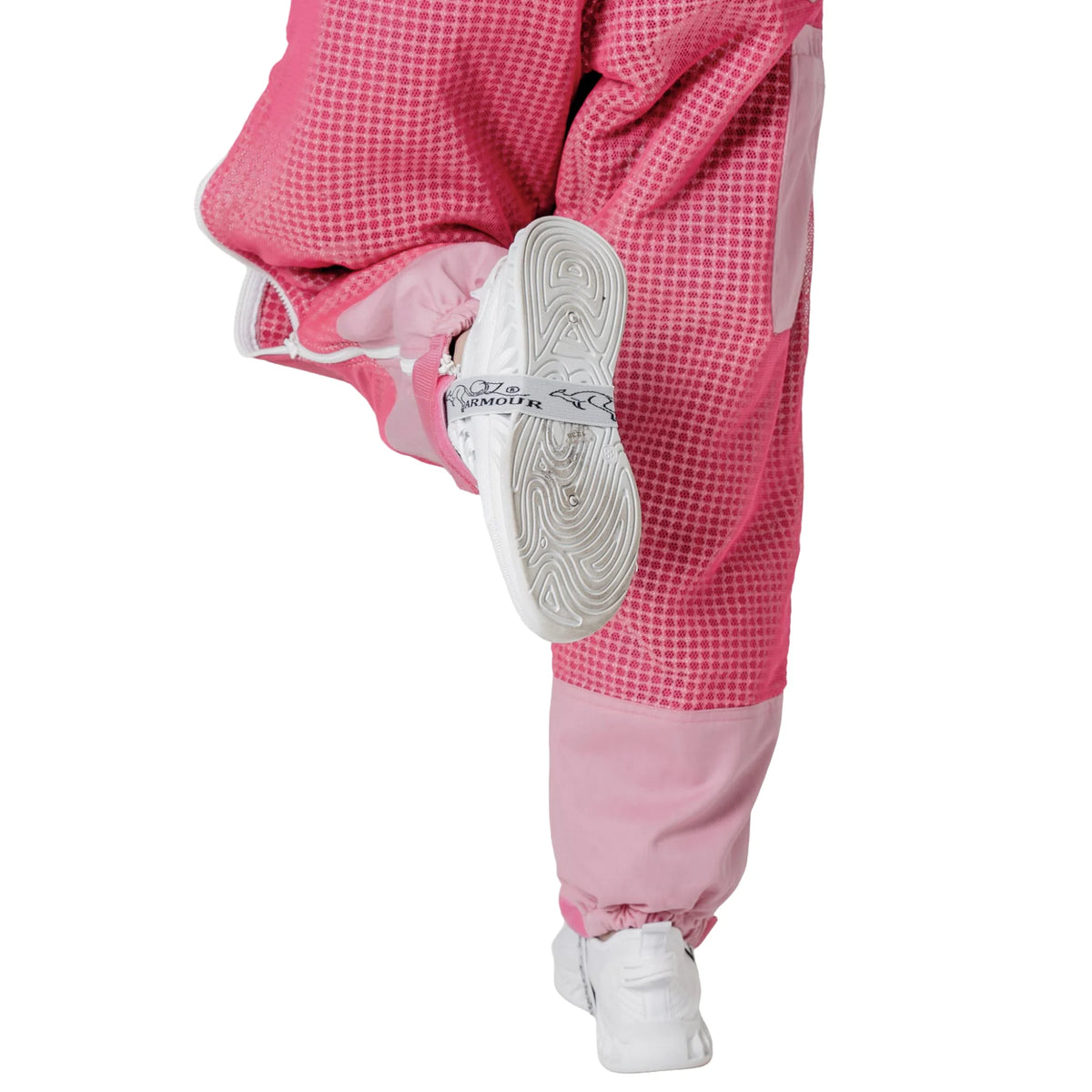 Close up of ankle cuff while kicking, on the OZ ARMOUR pink beekeeping trousers