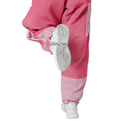 Close up of ankle cuff while kicking, on the OZ ARMOUR pink beekeeping trousers