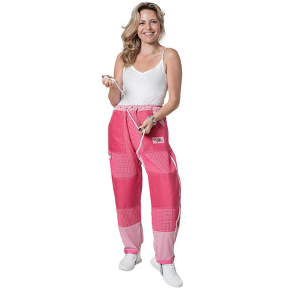 Woman wearing OZ ARMOUR pink beekeeping trousers holding the waist drawstring