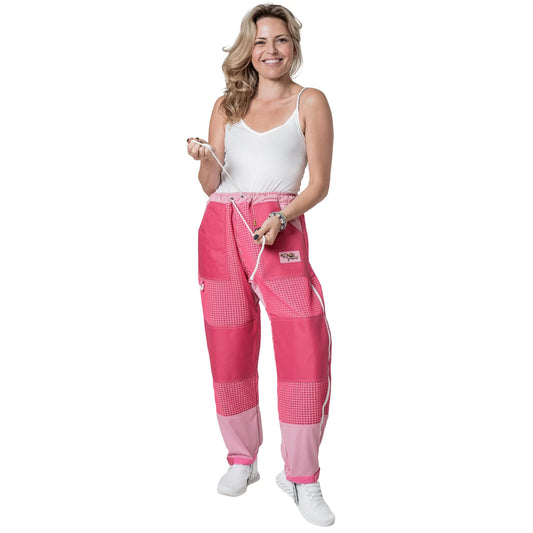 Woman wearing OZ ARMOUR pink beekeeping trousers holding the waist drawstring