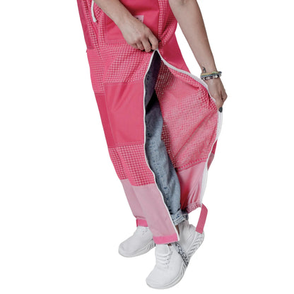 Close up of leg vent zipper open showing jeans underneath on the pink beekeeping trousers