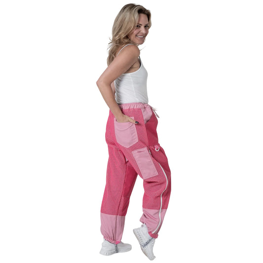 Woman walking in OZ ARMOUR pink beekeeping trousers, side view