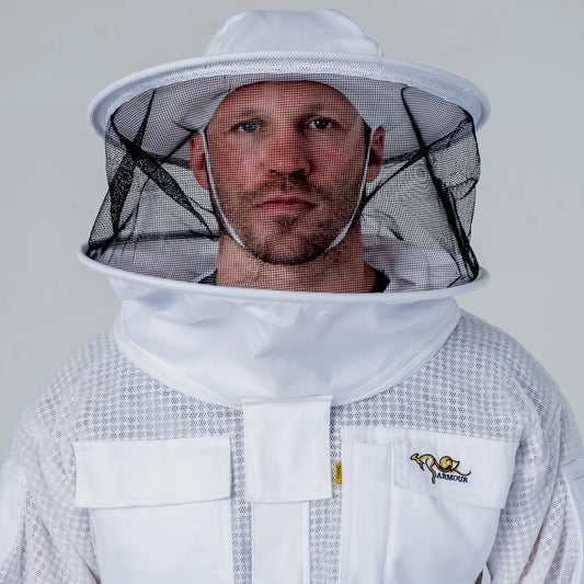 Man wearing OZ Armour white 3 layer beekeeping jacket with round hat veil, close up front view