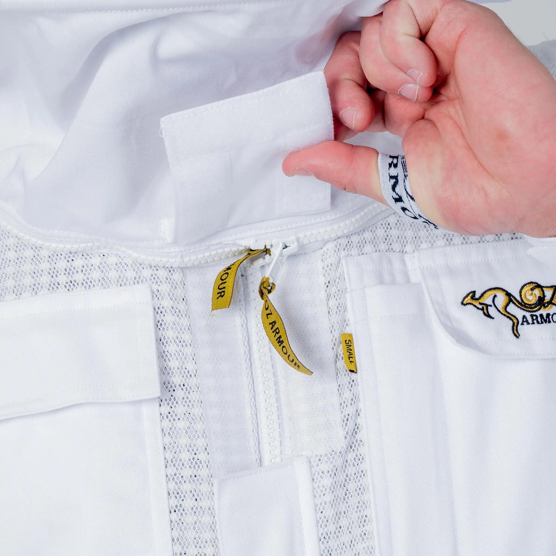 Close up of the collar zip and OZ Armour brand labels on the white 3 layer beekeeping suit